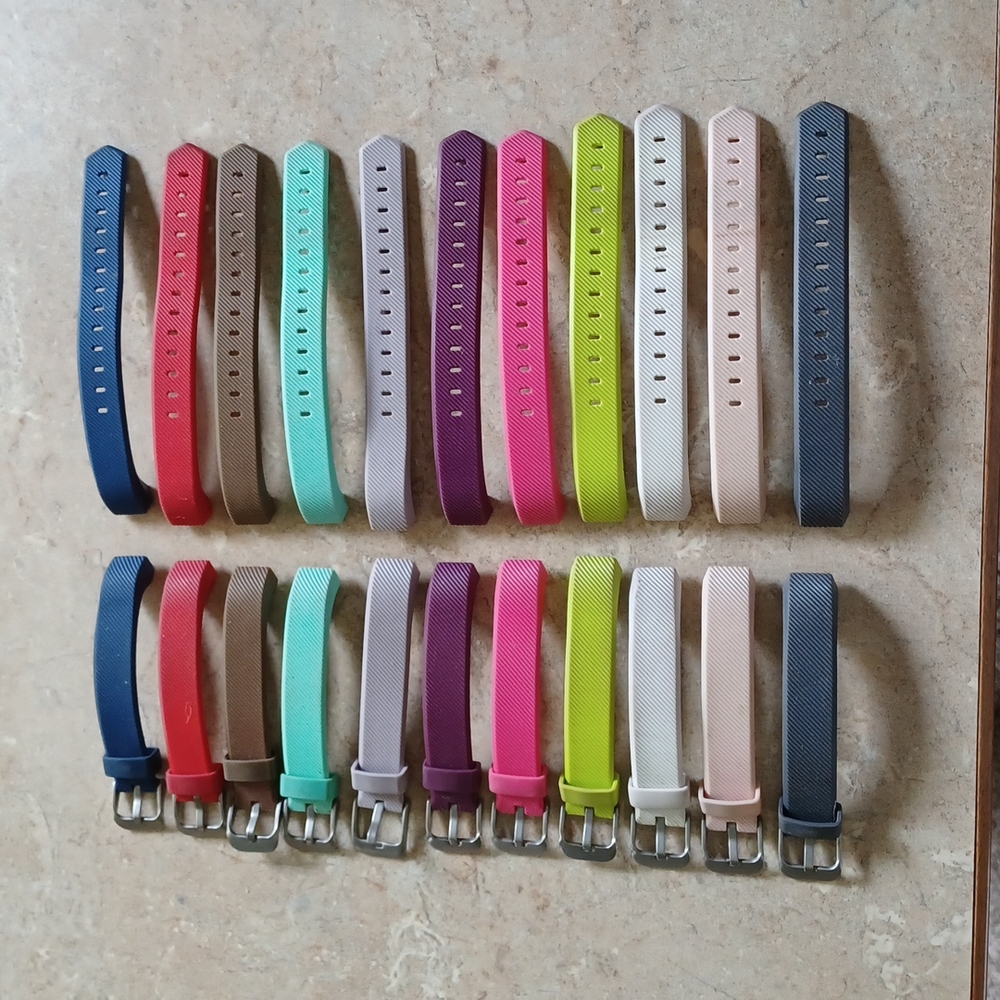 11 Fitbit Alta Charge bands and charger.